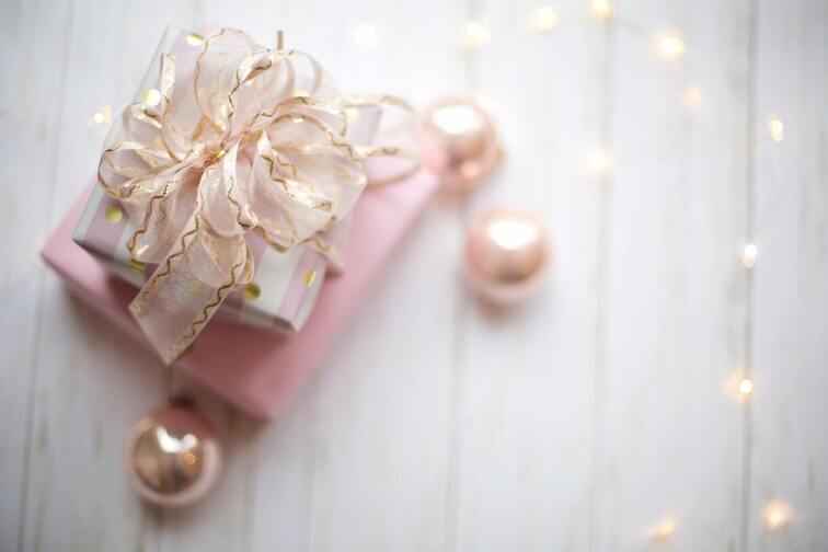 Two pink gift boxes with decorative shiny pink balls to show ways to give to others.